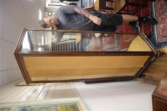 A 1920s mahogany bowfront shop display cabinet H.204cm